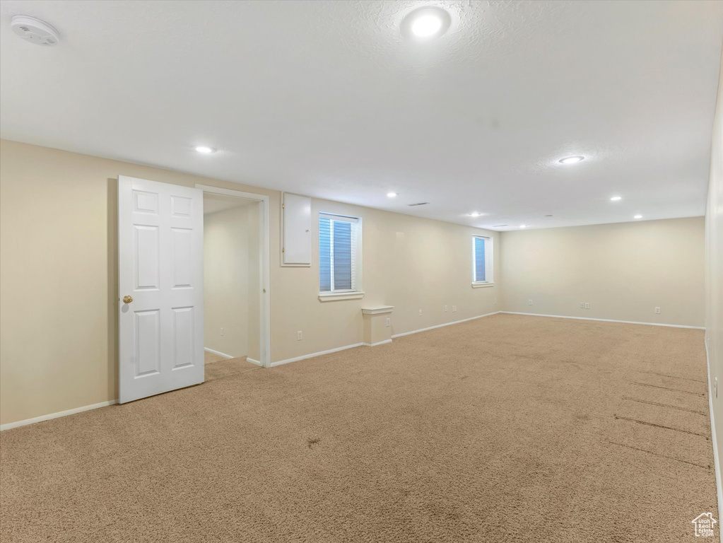 Basement featuring light colored carpet, recessed lighting, and baseboards