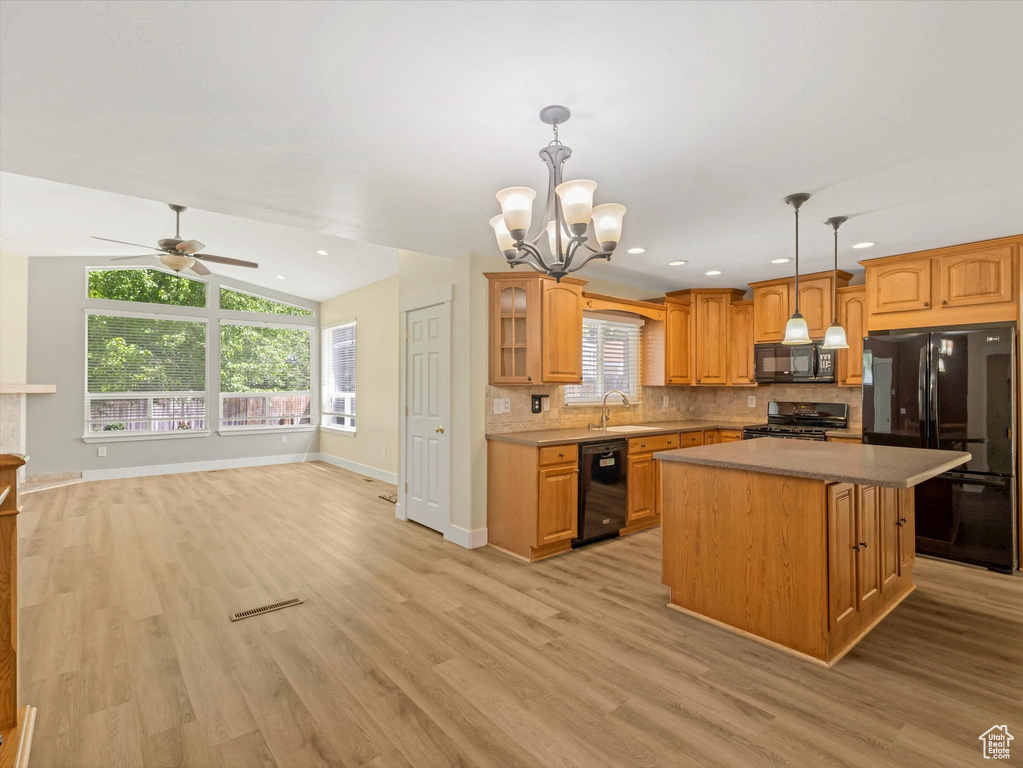 Kitchen featuring black appliances, a chandelier, a sink, backsplash, and ceiling fan