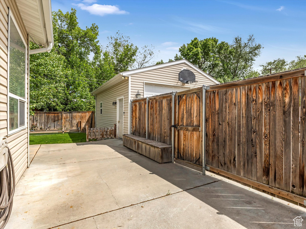 View of patio / terrace with a gate and a garage