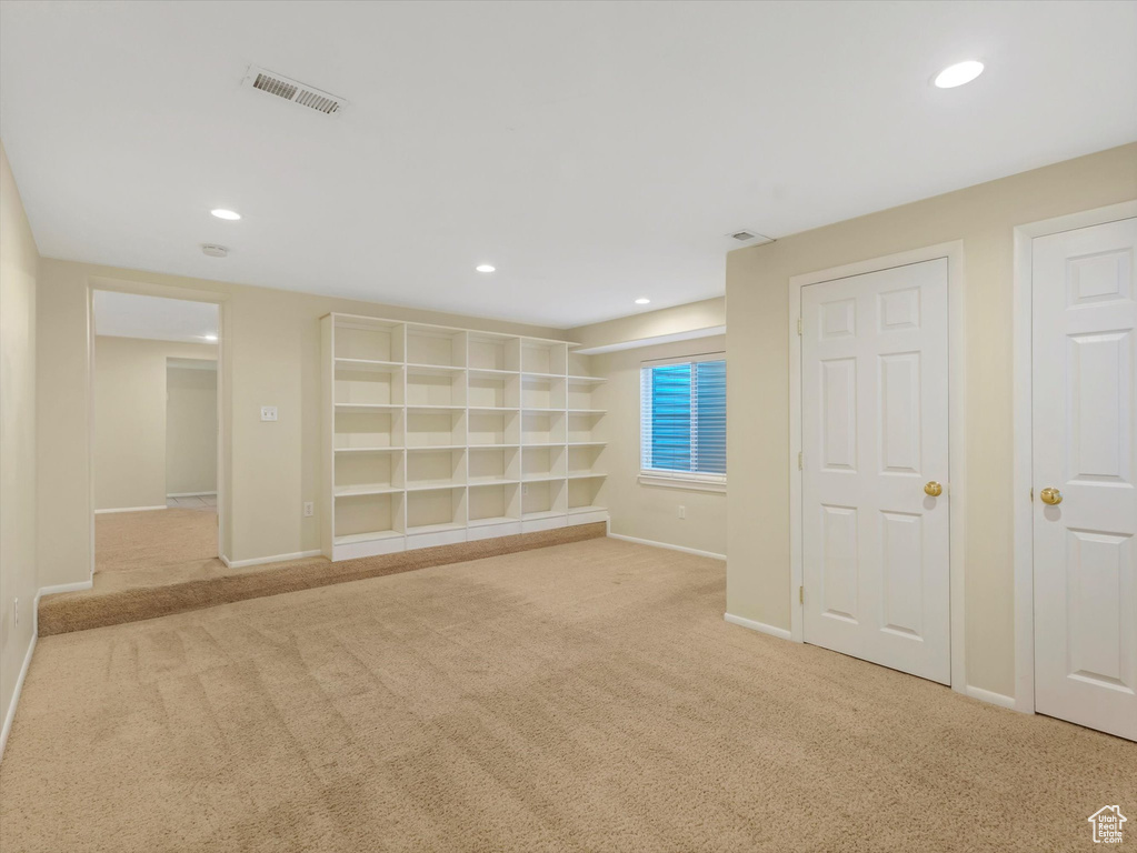 Basement featuring carpet floors, baseboards, and recessed lighting
