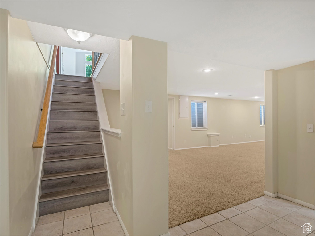 Stairs with tile patterned floors, carpet flooring, baseboards, and recessed lighting