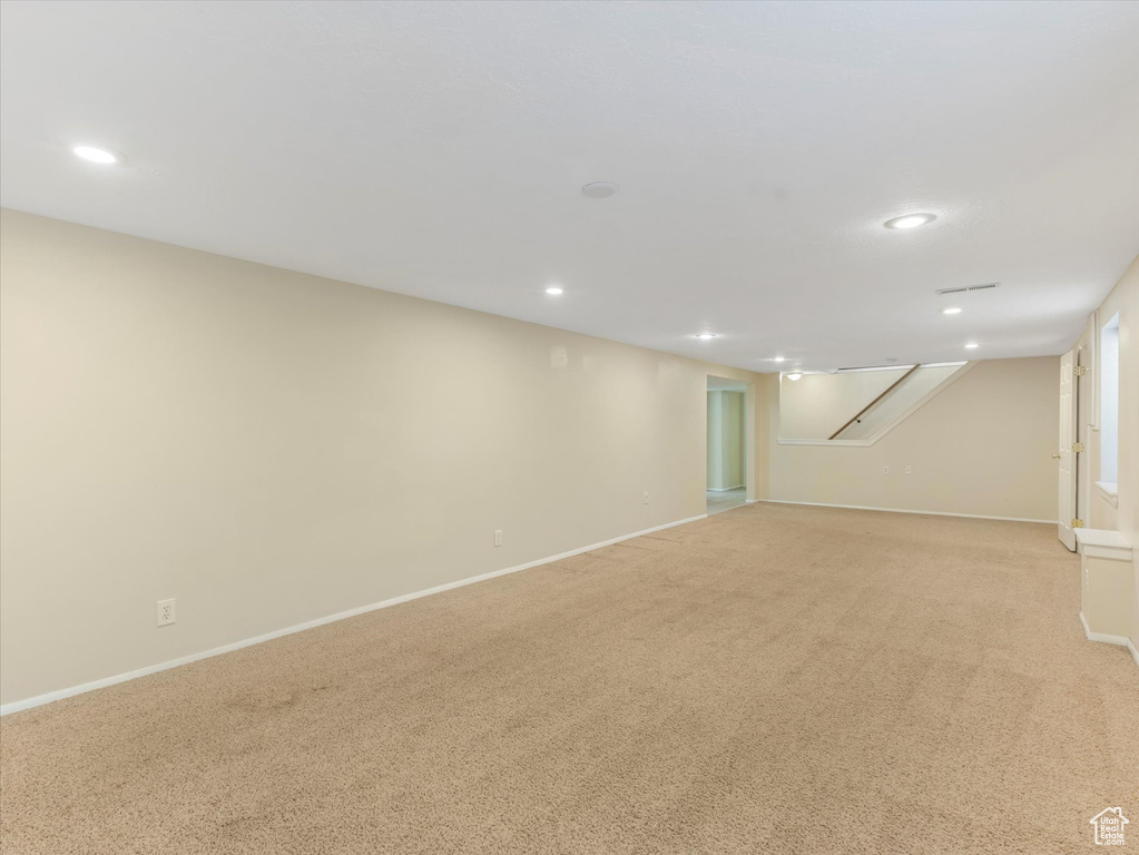 Finished basement featuring recessed lighting, light colored carpet, and baseboards