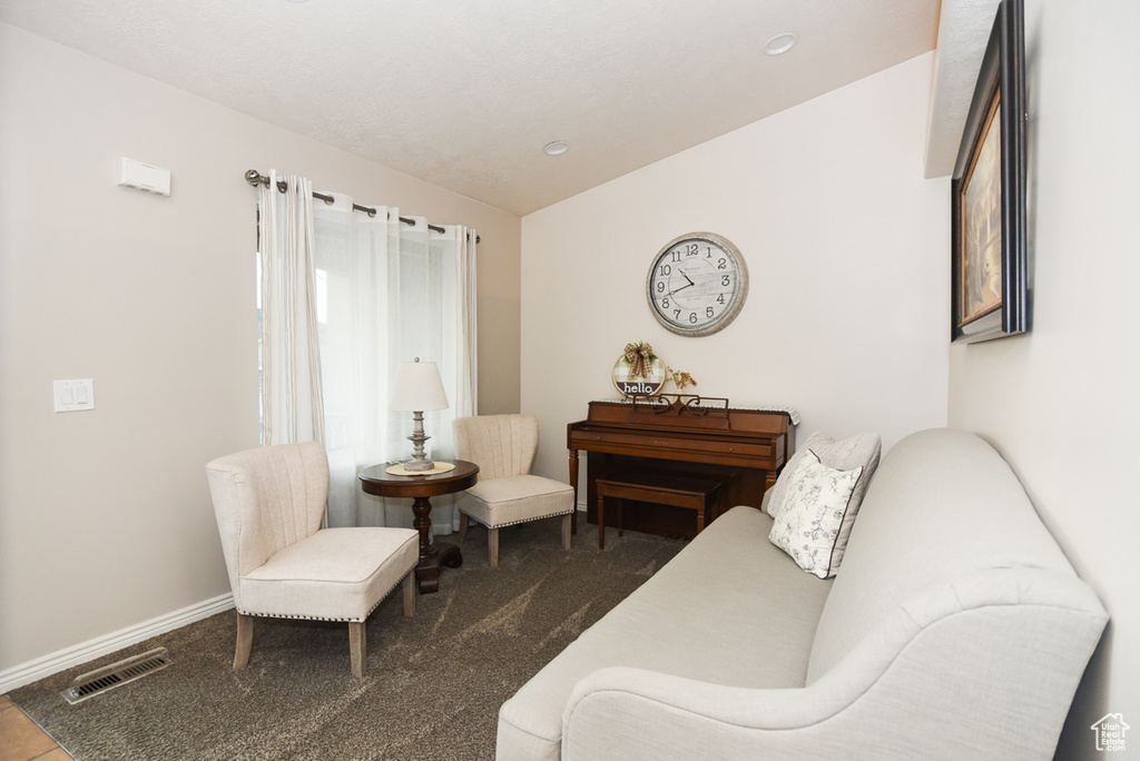 Living area with vaulted ceiling, carpet floors, recessed lighting, and baseboards