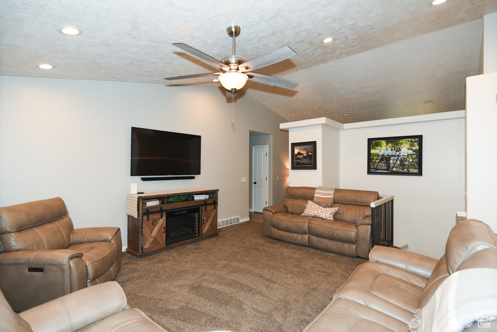 Carpeted living room with a ceiling fan, vaulted ceiling, recessed lighting, and baseboards