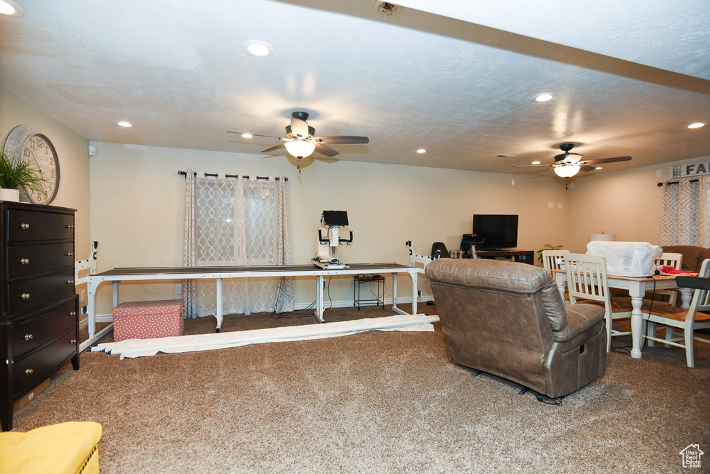 Living room featuring ceiling fan, carpet, recessed lighting, and a desk
