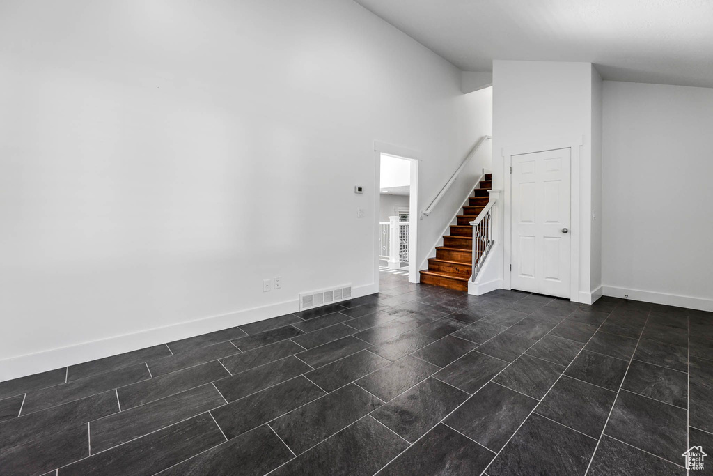 Entrance foyer with stairs and baseboards