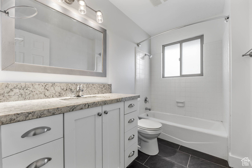 Bathroom featuring tile patterned flooring, vanity, toilet, and shower / bathtub combination