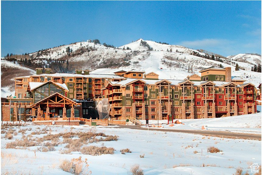 Snow covered property with a mountain view