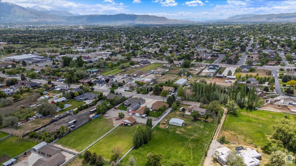 Aerial overview of property\'s location featuring a mountain backdrop and nearby suburban area