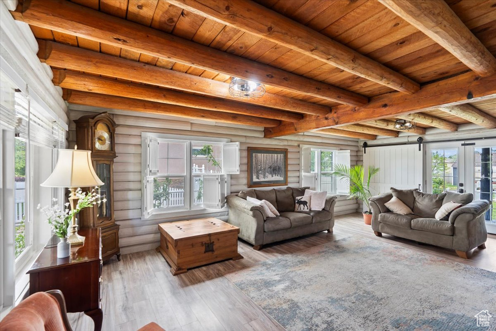 Living room with hardwood / wood-style flooring and wood ceiling with exposed beams