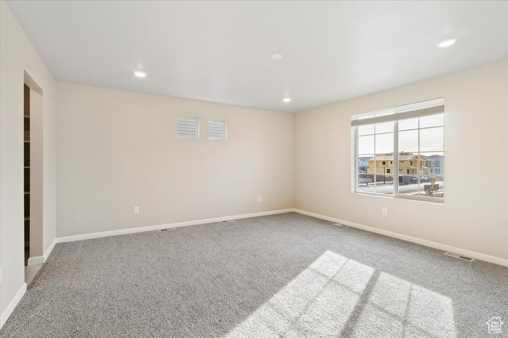 Carpeted spare room featuring recessed lighting and baseboards