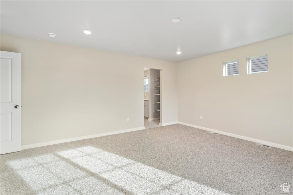 Empty room with carpet, baseboards, and recessed lighting