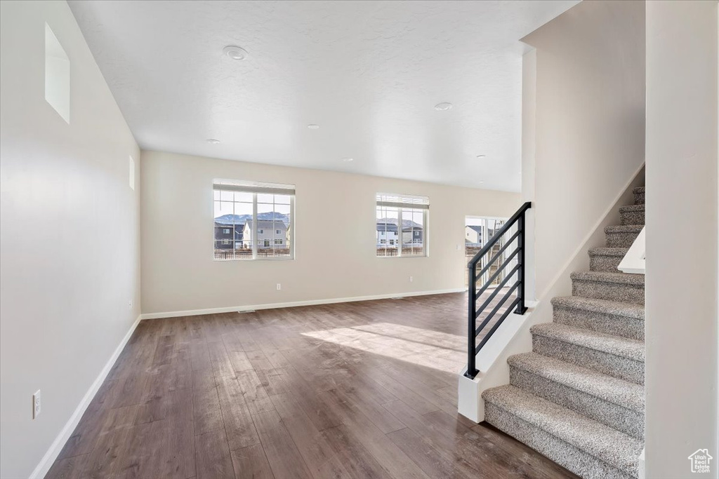 Entrance foyer with wood finished floors, stairs, and baseboards