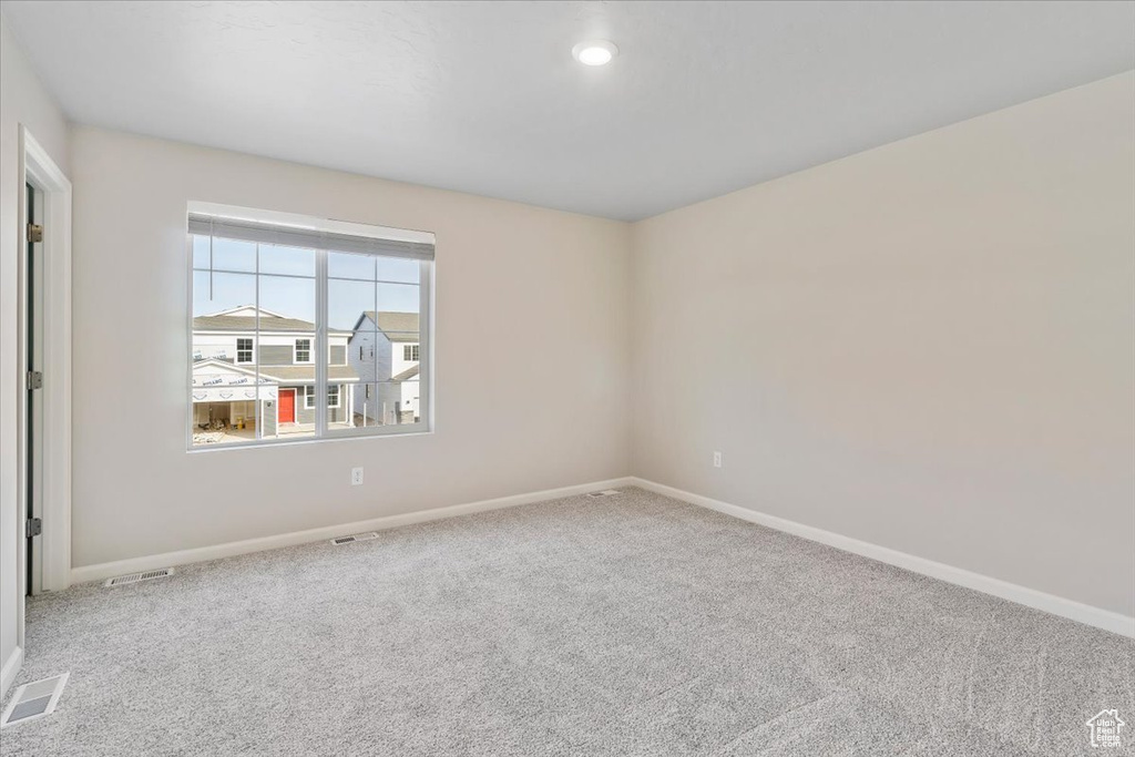 Empty room featuring baseboards, carpet floors, and recessed lighting
