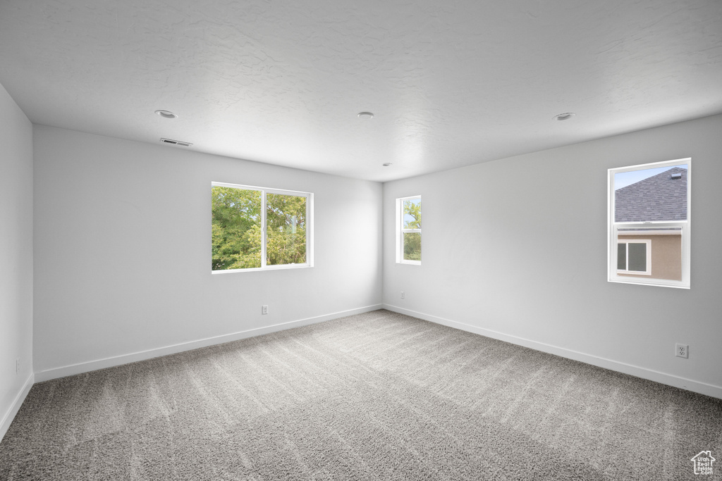 Unfurnished room with baseboards and carpet flooring