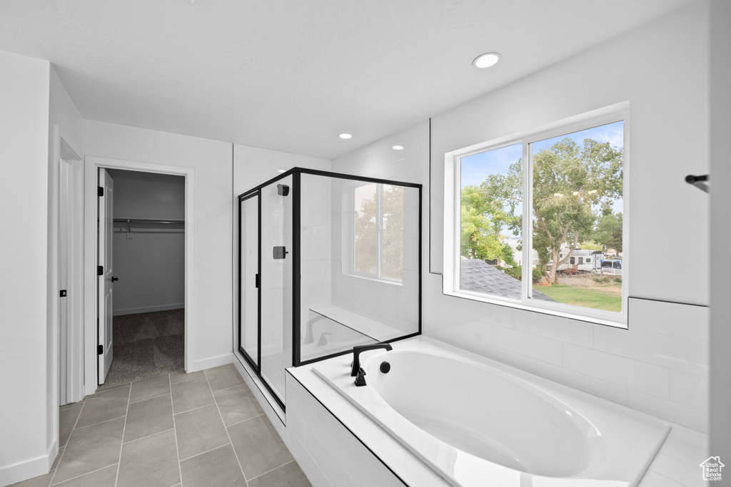 Bathroom featuring a shower stall, a bath, a walk in closet, tile patterned flooring, and recessed lighting