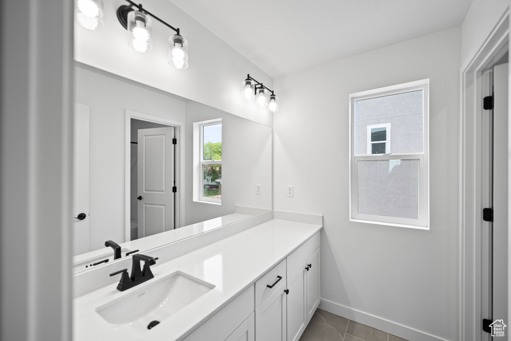 Bathroom with vanity and baseboards