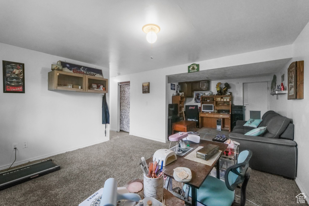 Carpeted living area with baseboards