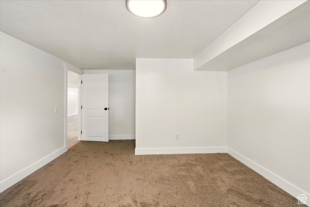 Unfurnished room featuring carpet floors and baseboards