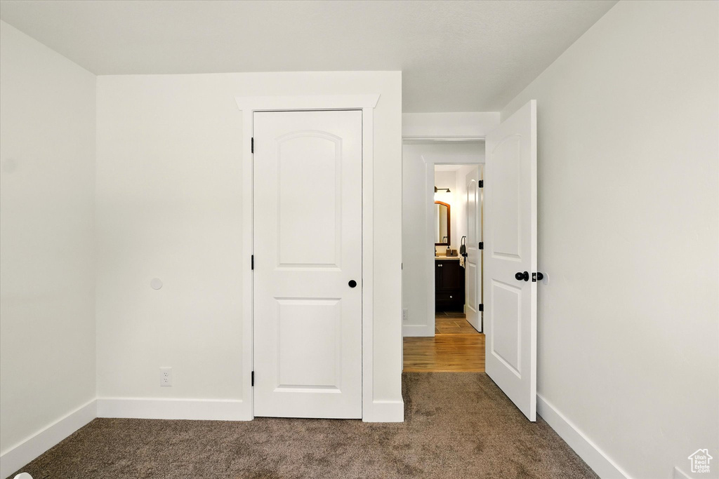 Unfurnished bedroom featuring carpet flooring and baseboards