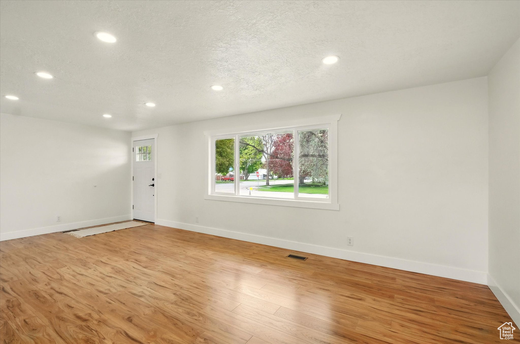 Foyer with recessed lighting, baseboards, and light wood-style flooring