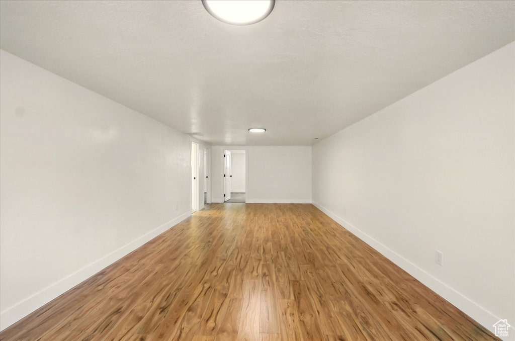 Spare room with light wood-type flooring and baseboards