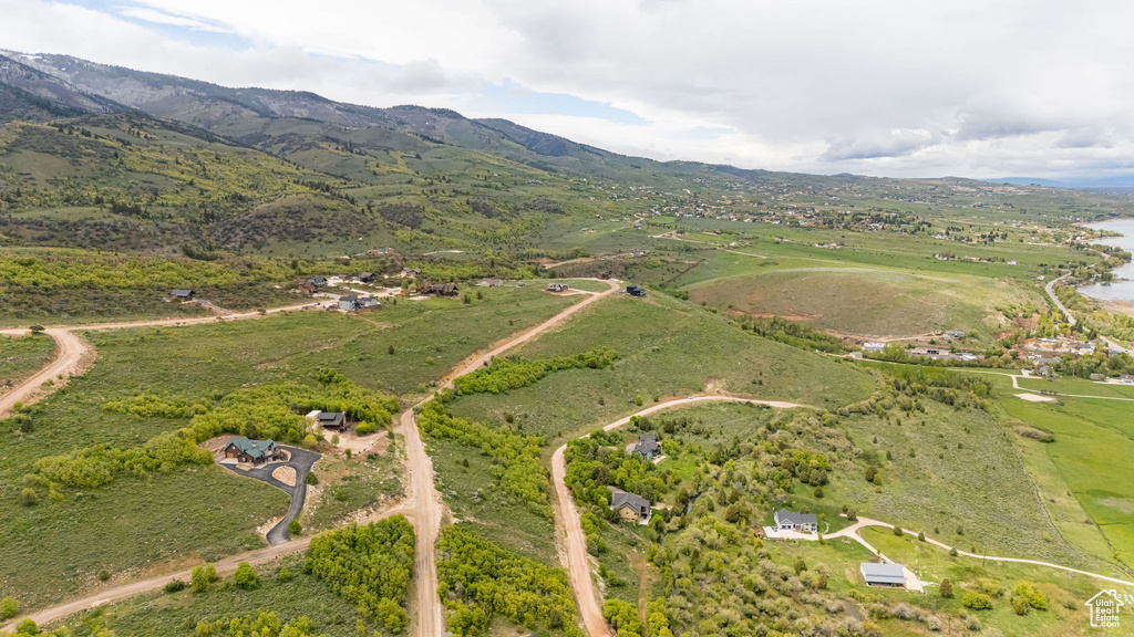 Aerial view of property and surrounding area with mountains and rural landscape