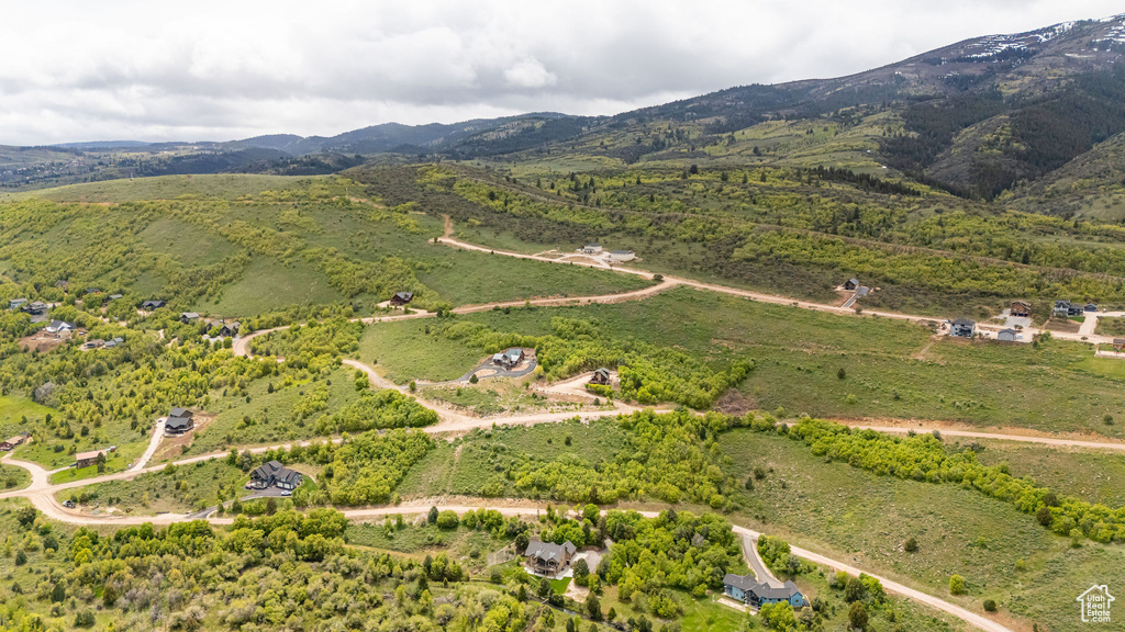 Aerial overview of property\\\'s location with a mountain backdrop and rural landscape