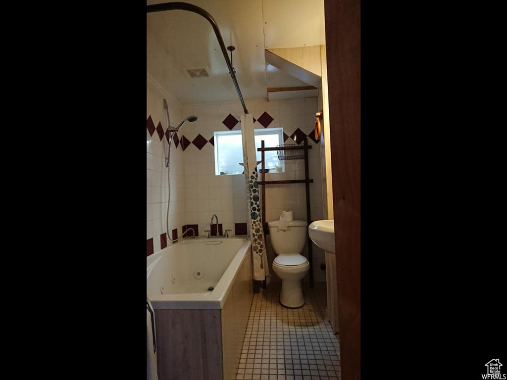 Bathroom featuring toilet, tile patterned floors, a combined bath / shower with jetted tub, and crown molding