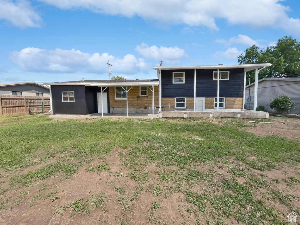 Rear view of property featuring a patio and brick siding