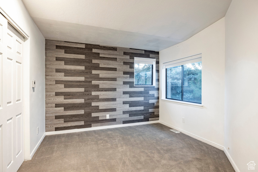 Spare room with carpet and baseboards