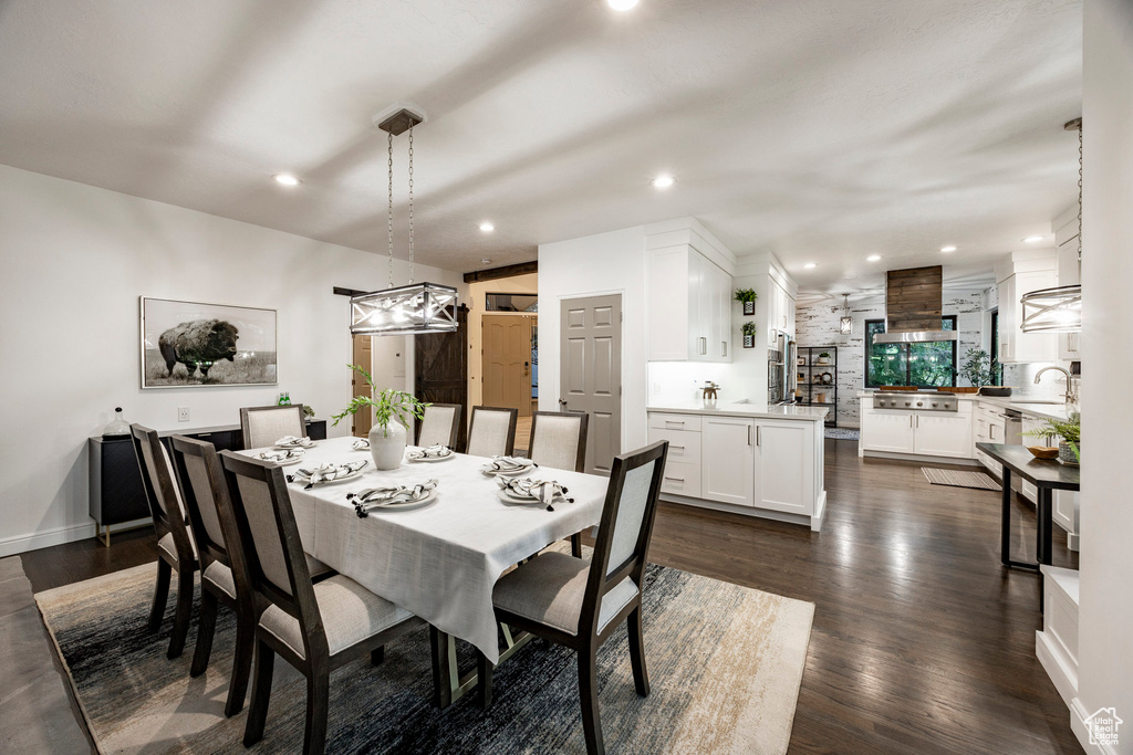 Dining space with dark wood-type flooring, recessed lighting, and baseboards