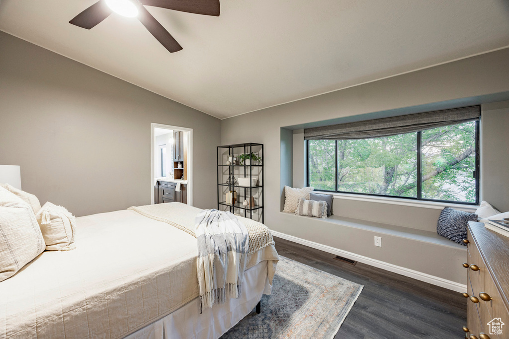 Bedroom featuring dark wood-style flooring, vaulted ceiling, baseboards, and a ceiling fan