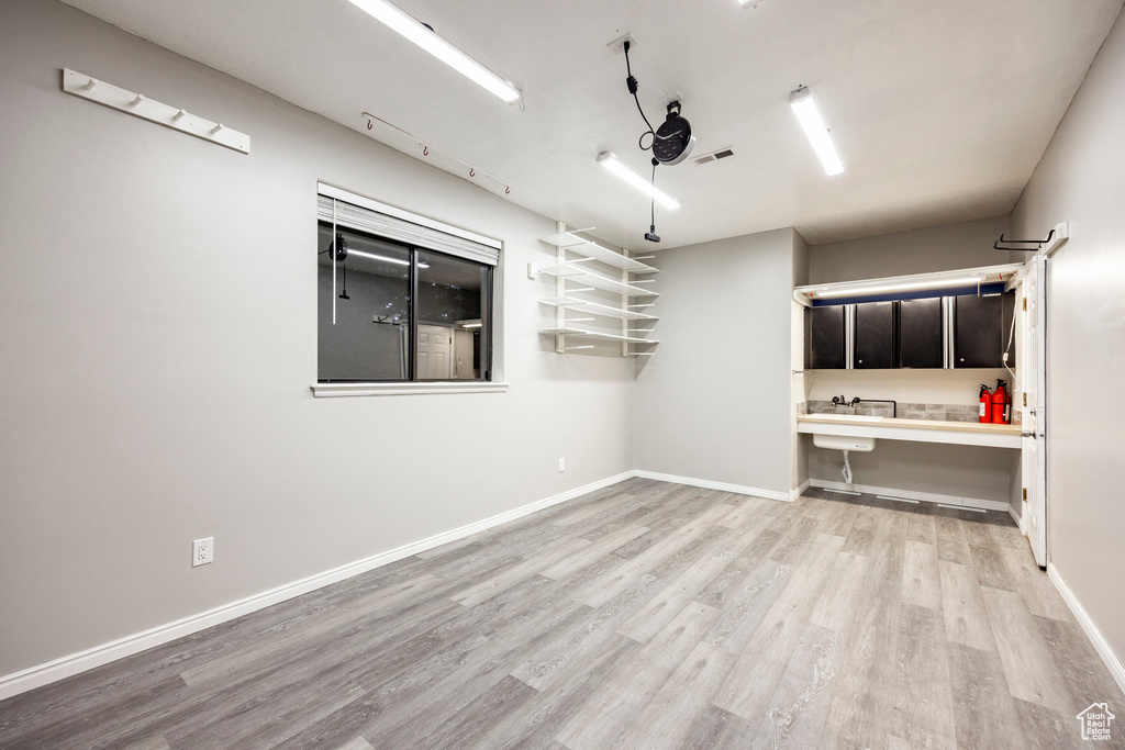 Spare room featuring light wood-style floors and baseboards