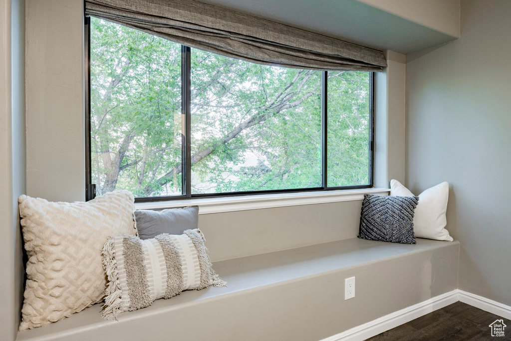 Sitting room featuring dark wood-style flooring and baseboards