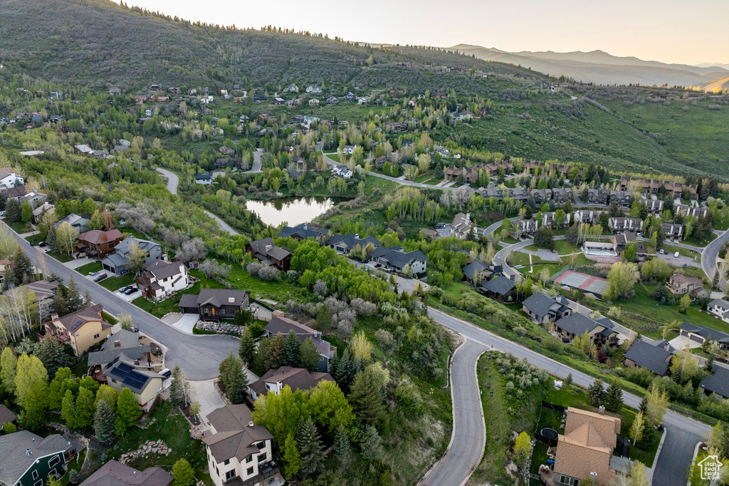 Aerial overview of property's location with nearby suburban area and a mountain backdrop