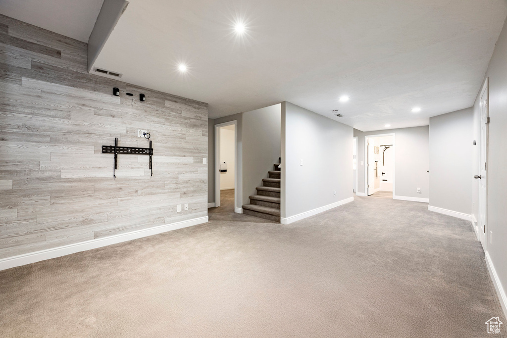 Finished basement featuring recessed lighting, stairway, baseboards, and carpet