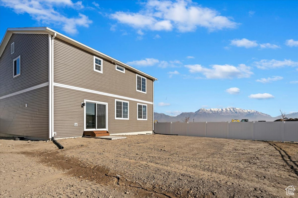 Back of property featuring a mountain view and entry steps
