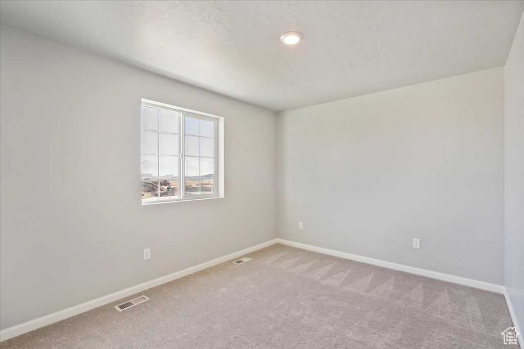Carpeted empty room with baseboards