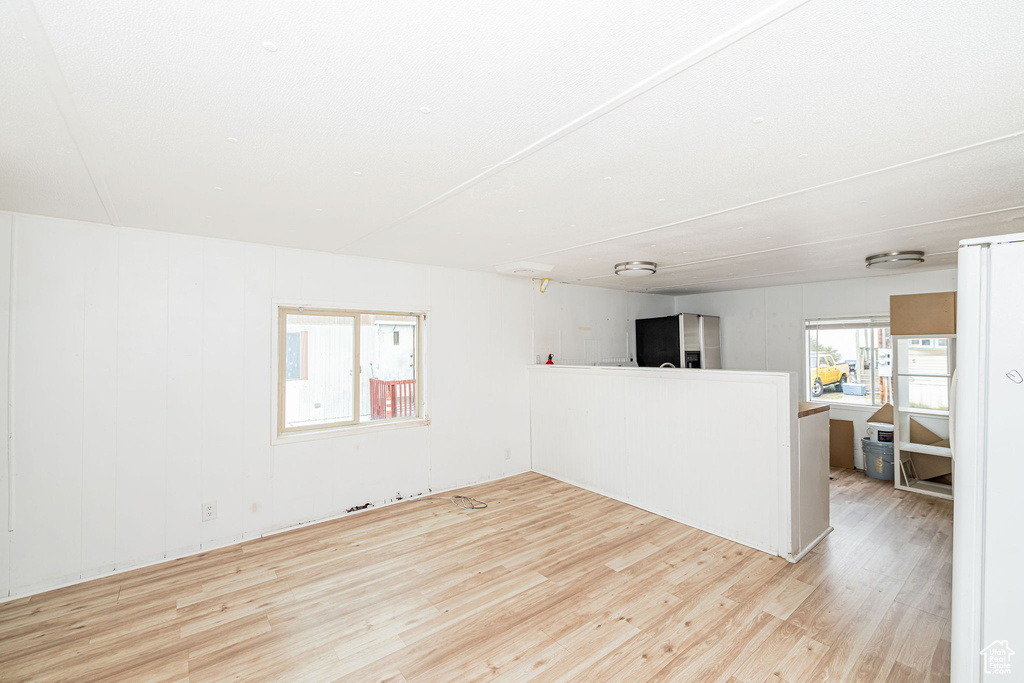 Unfurnished living room featuring wood finished floors