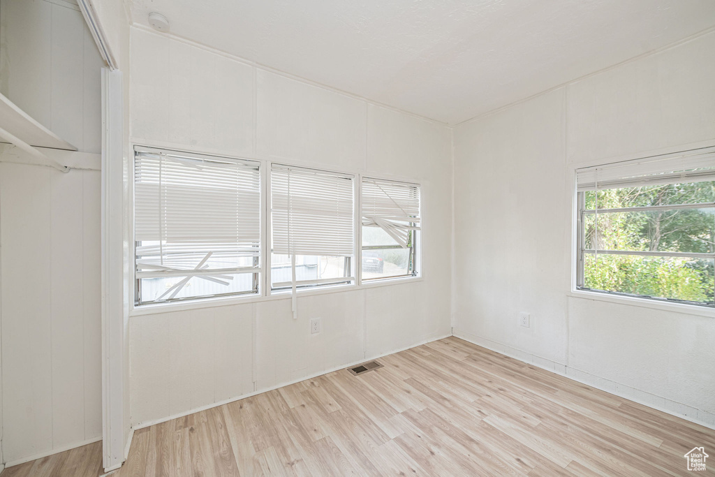 Unfurnished room with light wood finished floors and a smoke detector