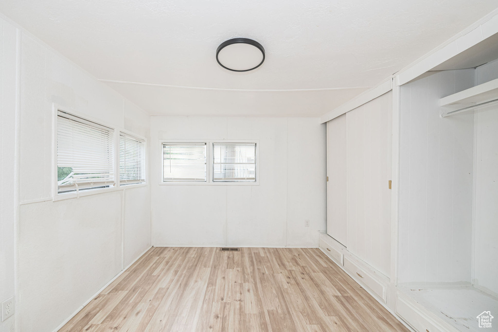 Unfurnished bedroom with wood finished floors