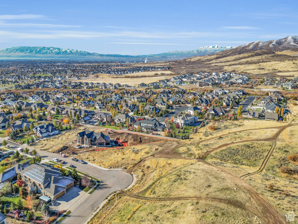 Aerial view of property's location featuring nearby suburban area and mountains