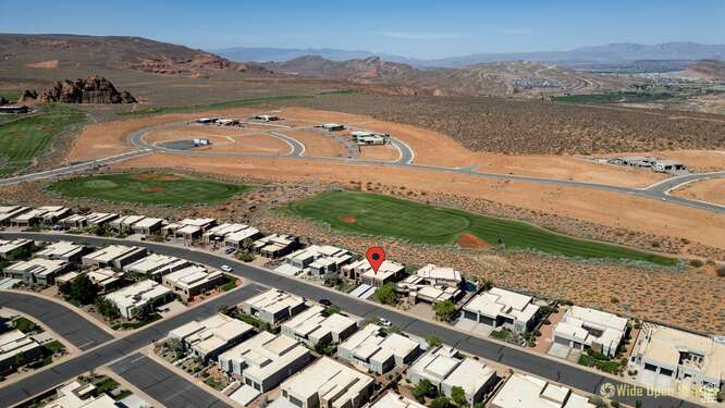 View of property location with a mountain backdrop, nearby suburban area, and a golf club