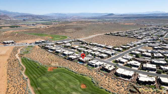 Aerial view of a mountainous background and a golf club