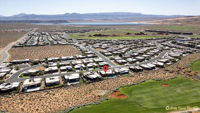 Aerial view of residential area with a golf course and a mountain backdrop