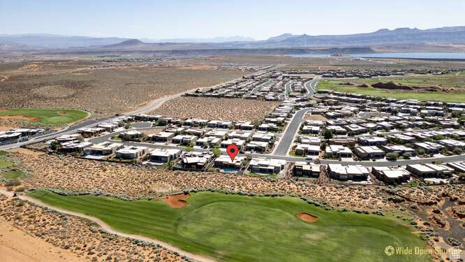 Aerial view of residential area featuring mountains and a golf club