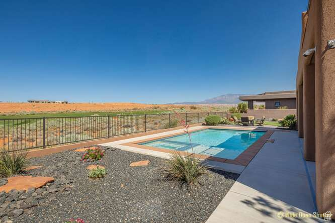 View of pool with a fenced backyard, a patio, and a mountain view