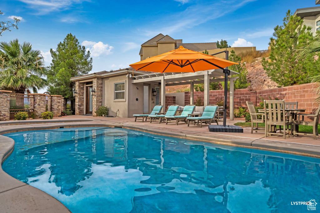 View of swimming pool featuring a patio and an outdoor structure