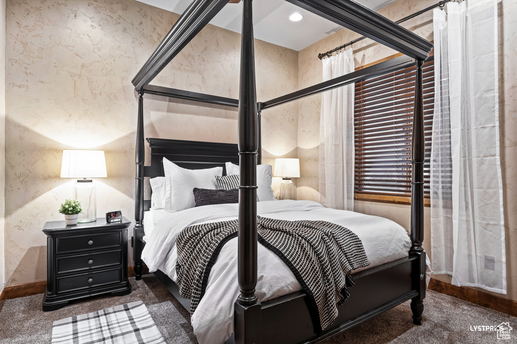 Bedroom featuring carpet floors and baseboards